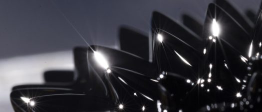 a spiked black ferromagnetic liquid, glistening with sharp reflections — symbolizing the precision, strength, and structured complexity of Hypersthene Capital’s data-driven trading strategies.